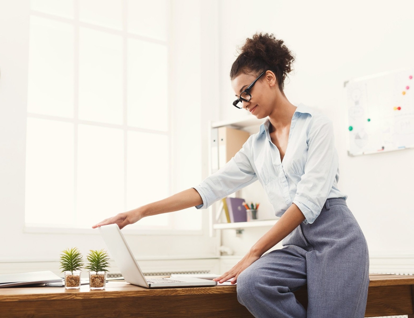 Business woman opening laptop at office